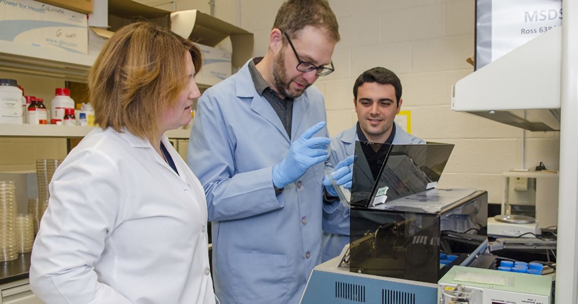 doctoral students in lab with faculty