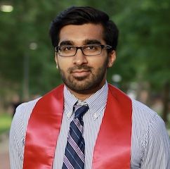Photo of Daniall Masood, in a red graduation cowl